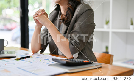 Stressed and professional Asian businesswoman clenched fists, having a serious conversation 98041220