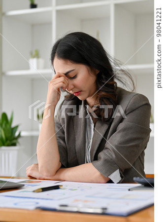 Portrait of a stressed Asian businesswoman worried about her project, having serious decision 98041221