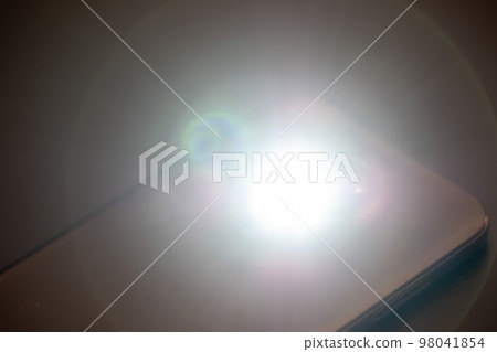 LED Flash or Flashlight of a Smartphone on black background 98041854
