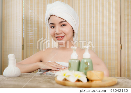 Young woman doing relaxing massage in spa salon. Female being massaged by a masseur. Spa and medicine concept Young woman doing relaxing massage in spa salon. Female being massaged by a masseur. Spa and medicine concept 98042180