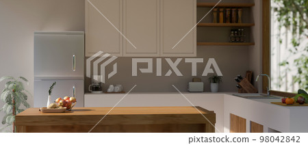 Minimal Scandinavian home kitchen with white counter, fridge, copy space on wood kitchen island 98042842