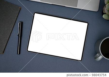 Modern workspace top view with tablet mockup, and supplies on blue background. 98043754