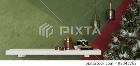 Christmas decor and copy space on wall shelf against the green wall, pendant lights and Christmas tree Christmas decor and copy space on wall shelf against the green wall, pendant lights and Christmas tree 98043762