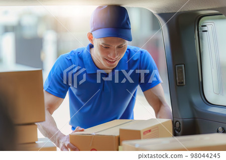 Asian courier with parcel and delivery logistic concept. Delivery man holding parcel box Asian courier with parcel and delivery logistic concept. Delivery man holding parcel box 98044245