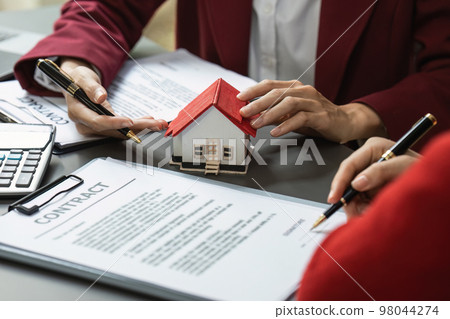 Real Estate Agent explain insurance and agreement contract to client before sign contract. Property insurance and security concept 98044274