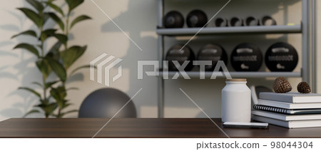 Copy space on tabletop with decor against blurred fitness with sport equipments in background Copy space on tabletop with decor against blurred fitness with sport equipments in background 98044304