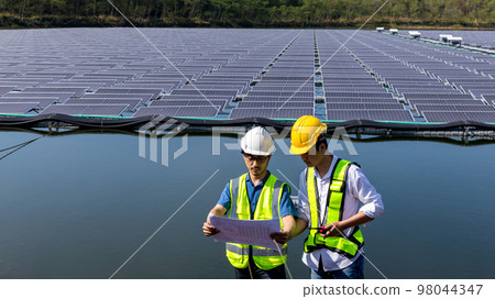 Engineer working setup Floating solar panels or solar cell Platform system on the lake. 98044347