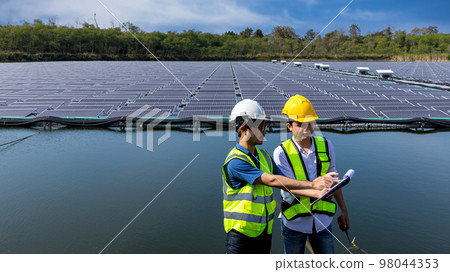 Engineer working setup Floating solar panels or solar cell Platform system on the lake. 98044353