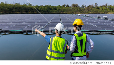 Engineer working setup Floating solar panels or solar cell Platform system on the lake. 98044354
