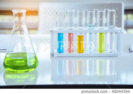 Science chemistry glass tubes objects on lab background. Liquid tube biology laboratory chemical fluid scientist object testing tubes medical glassware. Chemistry scientific pharmaceutical background Science chemistry glass tubes objects on lab background. Liquid tube biology laboratory chemical fluid scientist object testing tubes medical glassware. Chemistry scientific pharmaceutical background 98044394