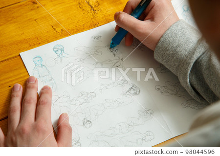 Hands of a person practicing drawing Hands of a person practicing drawing 98044596