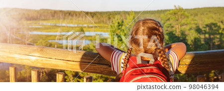 Girl standing on the observation tower on the Viru bog. Girl standing on the observation tower on the Viru bog. 98046394