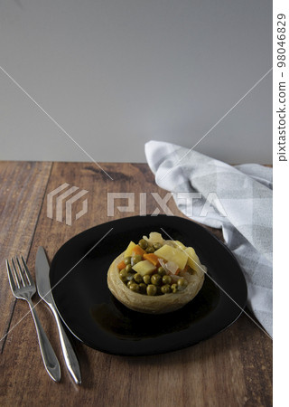 Delicious artichokes on black plate Delicious artichokes on black plate 98046829