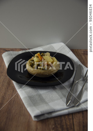 Delicious artichokes on black plate 98046834