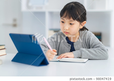Girl studying on a tablet Online class 98047419