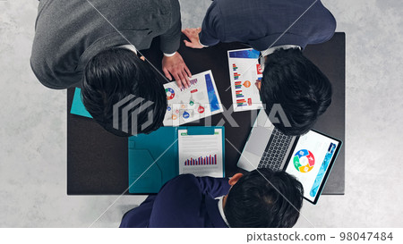 A group of business people having a meeting in the office A true bird's-eye view A group of business people having a meeting in the office A true bird's-eye view 98047484