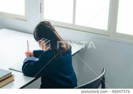 A girl studying in the classroom 98047578