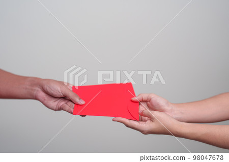 People hand giving Chinese red envelope, money gift for happy Lunar New Year holiday People hand giving Chinese red envelope, money gift for happy Lunar New Year holiday 98047678