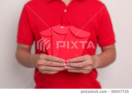 man holding Chinese red envelope, money gift for happy Lunar New Year holiday man holding Chinese red envelope, money gift for happy Lunar New Year holiday 98047726