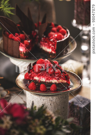 Slice of cheesecake with raspberry sauce Slice of cheesecake with raspberry sauce 98047879