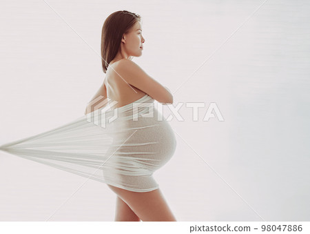 Pregnant woman happy portrait in with spring flowers. New season and new life concept. Pregnancy in 3rd trimester. Asian woman expecting baby feeling happiness free living healthy lifestyle outdoors Pregnant woman happy portrait in with spring flowers. New season and new life concept. Pregnancy in 3rd trimester. Asian woman expecting baby feeling happiness free living healthy lifestyle outdoors 98047886