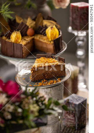 Slice of layered chocolate mousse cake 98047941