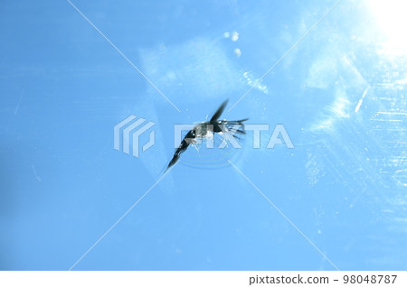 broken windshield of vehicle, blur background 98048787