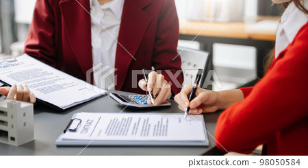 Salesman Hands On House Model , Small Toy House Small Mortgage Property insurance and concepts real estate. 98050584