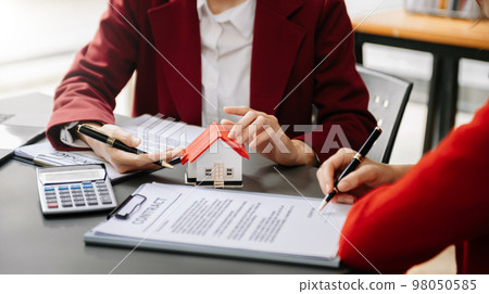 Considering buying a home, investing in real estate. Broker signs a sales agreement. agent, lease agreement, successful deal in office Considering buying a home, investing in real estate. Broker signs a sales agreement. agent, lease agreement, successful deal in office 98050585