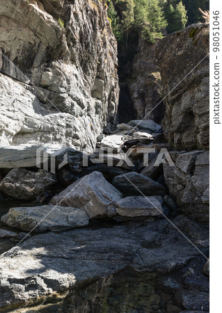 Bed of Lillaz waterfall divided by thousands of years of formation in granite alpine rocks 98051046