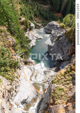 View from above of Lillaz waterfall and emerald pond below 98051054