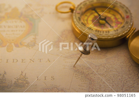 A pin and a compass on an antique map A pin and a compass on an antique map 98051165