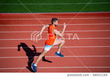 athletic guy run. challenge and competition. marathon speed. sprinter. man on running track. 98052189