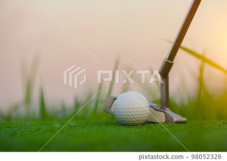 Golf clubs and golf balls on a green lawn in a beautiful golf course. Golf clubs and golf balls on a green lawn in a beautiful golf course. 98052326