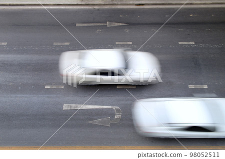 Motion blurred of automobile moving on road with speed on top view, traffic on city, background 98052511
