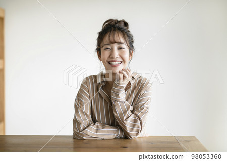 A young woman smiling looking at the camera A young woman smiling looking at the camera 98053360
