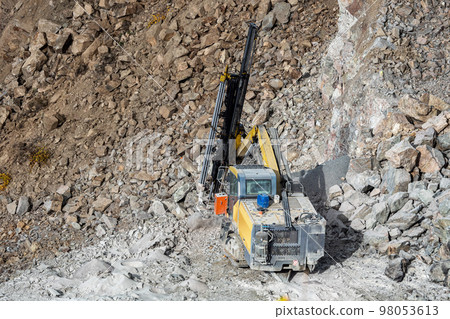 Drilling machine in open cast mining quarry Drilling machine in open cast mining quarry 98053613