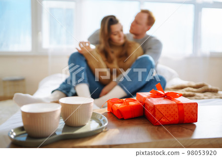 Couple in love relaxing at home on bed while they hug each other. Valentine's Day, holiday concept. 98053920