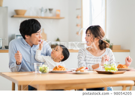 A young family eating A young family eating 98054205