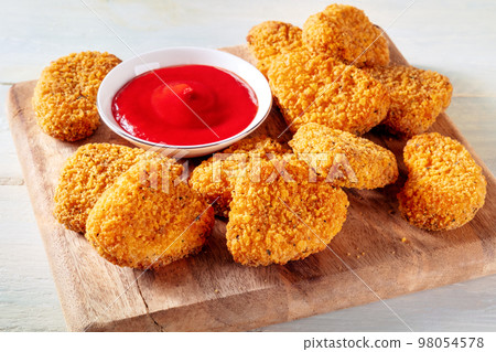 Chicken nuggets with bbq sauce on a wooden board Chicken nuggets with bbq sauce on a wooden board 98054578