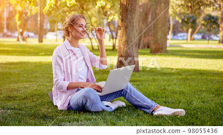 Businesswoman sitting grass Businesswoman sitting grass 98055436