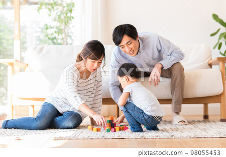 Young family relaxing in the living room Young family relaxing in the living room 98055453