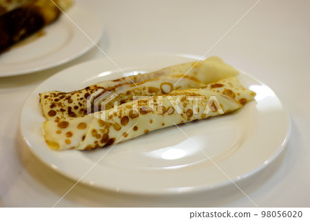 pancakes stuffed on a white plate in the kitchen pancakes stuffed on a white plate in the kitchen 98056020