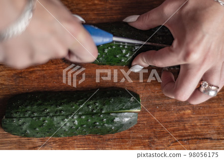 on a cutting board cut fresh cucumbers on a cutting board cut fresh cucumbers 98056175