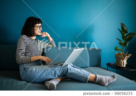 Attractive woman using laptop for communication, video chatting. Online meeting in video call. 98056255