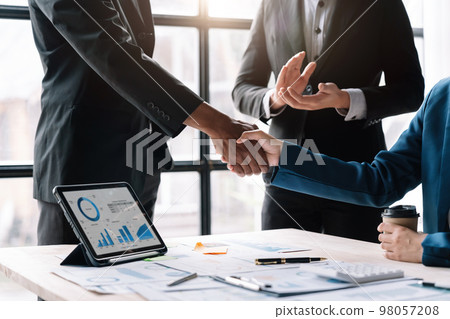Business people shaking hands, finishing up meeting, business etiquette, congratulation, merger and acquisition concept Business people shaking hands, finishing up meeting, business etiquette, congratulation, merger and acquisition concept 98057208