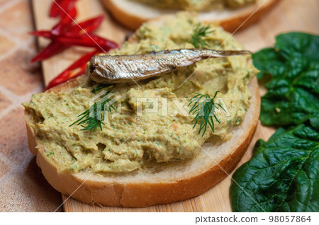 Sandwich with fish pate and sprats. 98057864