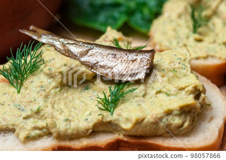 Sandwich with fish pate and sprats. 98057866