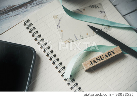 Smartphone, notebook, pen and ribbon 98058555