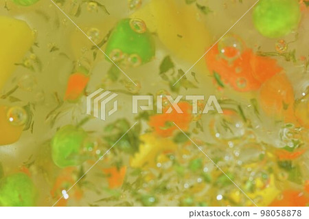 Close-up view of the vegetables with carrots, peas, cauliflower, corn, chopped potatoes and parsley in water background. Texture of boiling soup vegetables. Flat design, top view. Horizontal macro Close-up view of the vegetables with carrots, peas, cauliflower, corn, chopped potatoes and parsley in water background. Texture of boiling soup vegetables. Flat design, top view. Horizontal macro 98058878